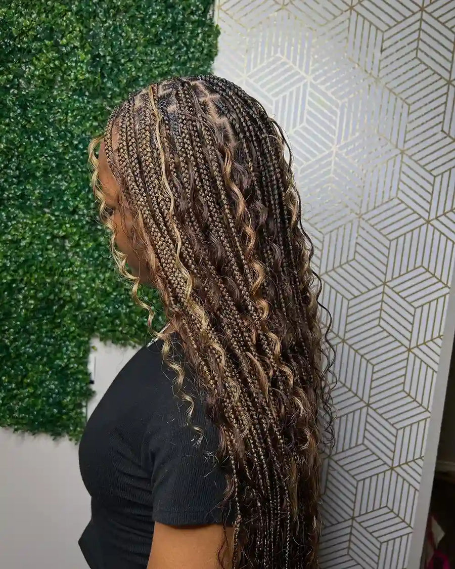 Long mixed color boho braids with loose curly pieces, hairstylist in College Station, TX