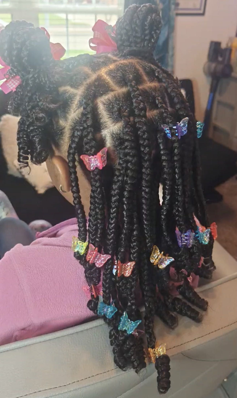 Kids box braids with butterfly clips and braided buns, hairstylist in Texas City, TX