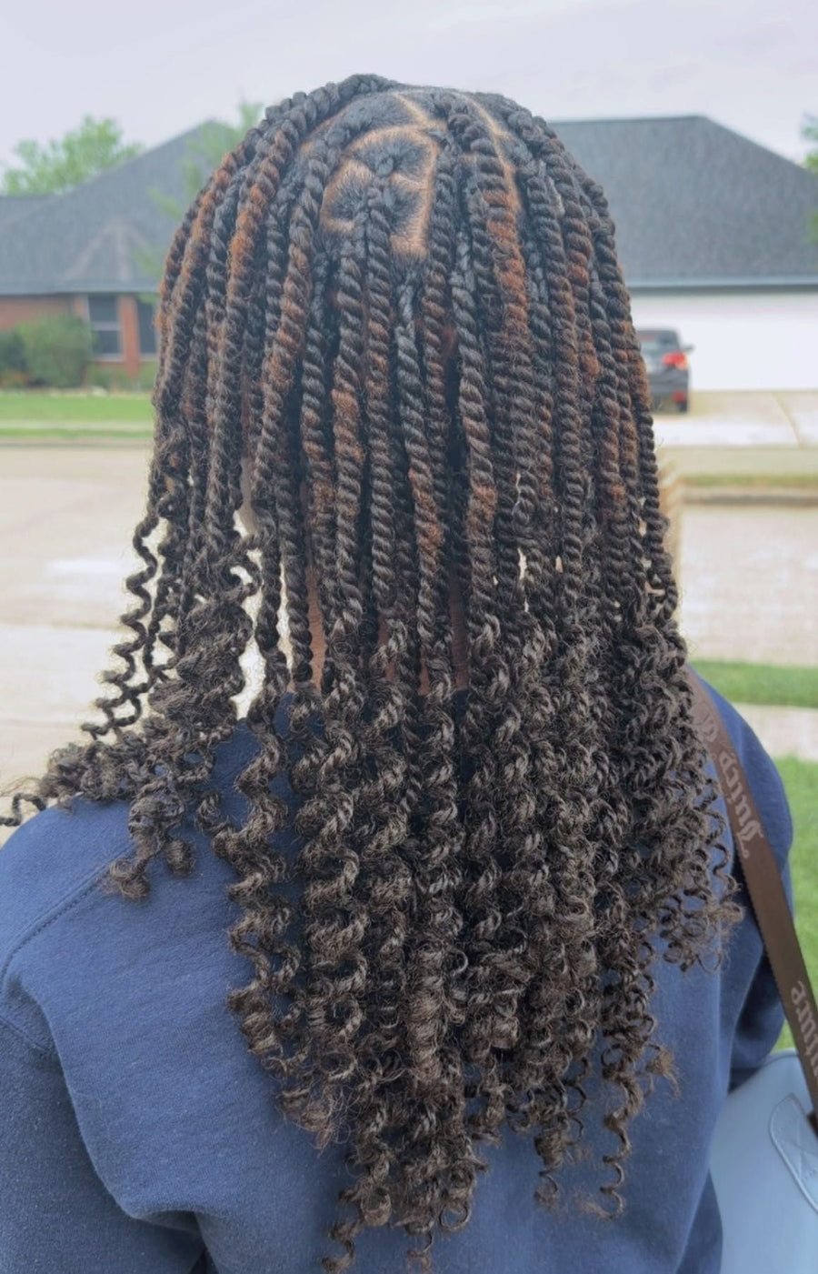 Medium passion twists with curly ends and natural black color, hairstylist in Texas City, TX