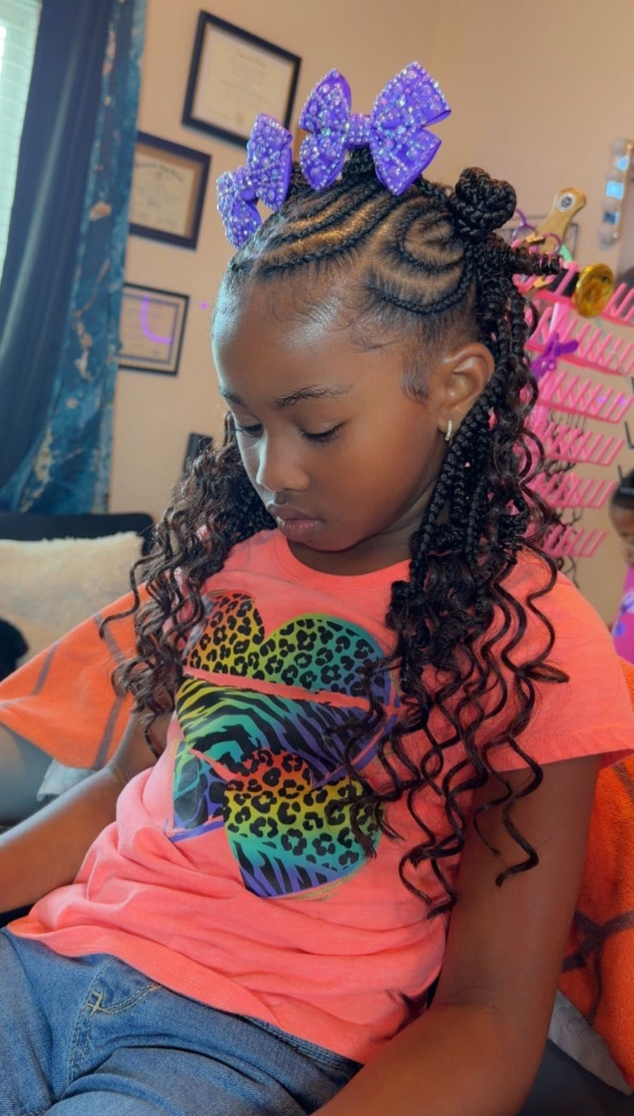 Kids boho braids with curly pieces and purple bow accessories, hairstylist in Texas City, TX