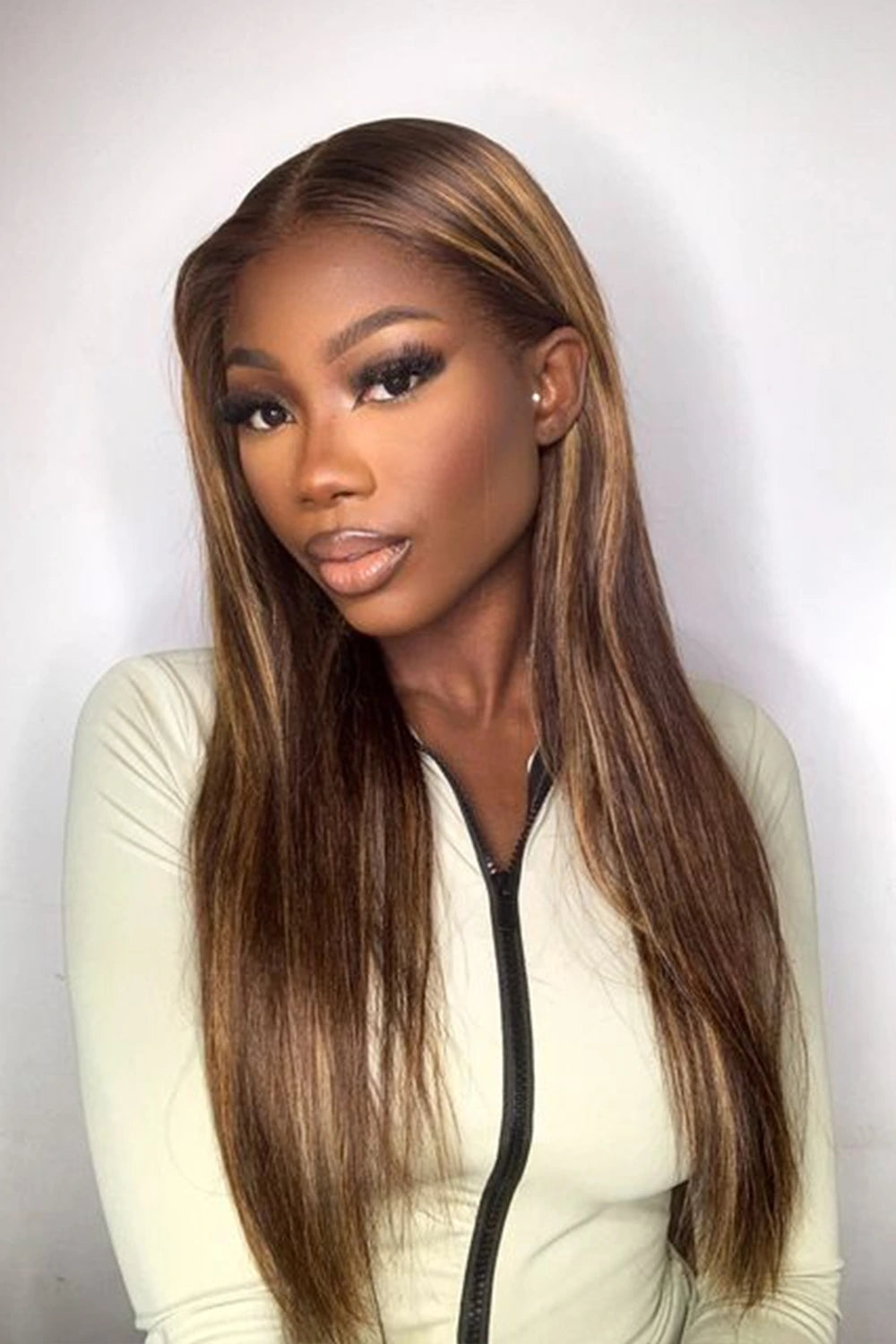 A model is showing off ygwigs' 13x6 glueless hd lace brown wig with blonde highlights bone straight 1